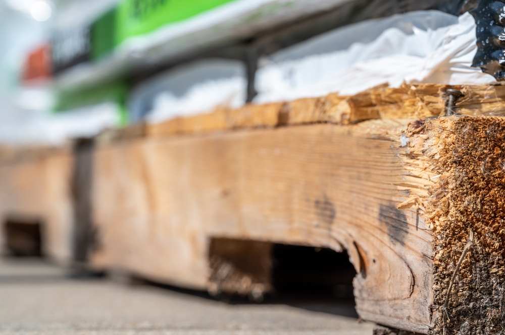 What are the environmental benefits of using used timber pallets?